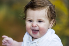 Gleeful baby in Central Park in fall