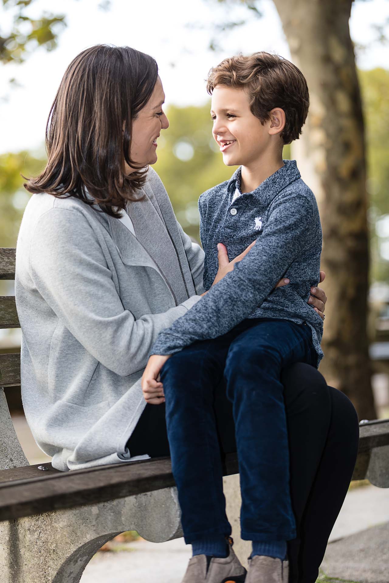 Mother-and-son-chatting-on-park-bench