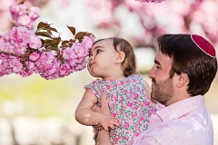 father-lifts-daughter-to-cherry-blossoms