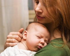 Newborn on mom\'s shoulder