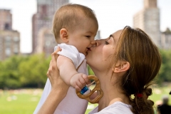 Mom kissing baby in Central Park